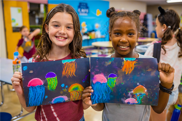 SACC artwork on black paper with chalk